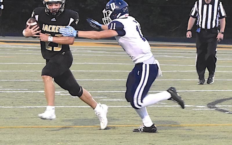 Gary Corsair • Clay County Progress Hayesville's Kaden Ledford, No. 25, uses a straight-arm on the way to gaining a first-down against Enka