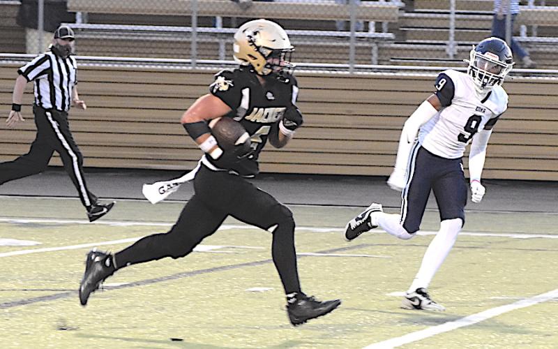Gary Corsair • Clay County Progress Hayesville's Tre Graves outjets an Enka Jet on the way to one of his three touchdowns.