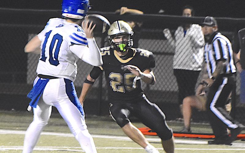 Linebacker Kaden Ledford, 25, pressures the quarterback as the Hayesville defense makes a stand.