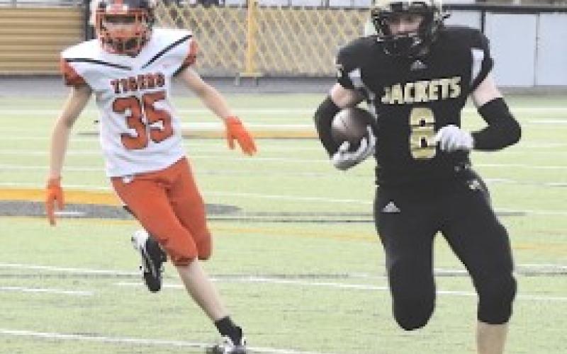 Gary Corsair • Clay County Progress Brett Hanna, No. 8, sets his sights on the end zone as he finds daylight around left end. Hanna scored on runs of 41 and 45 yards and split the uprights on two point-ofter kicks.
