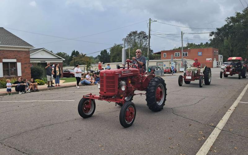 Buddy Lowe is among those rolling around the Hayesville town square Saturday during the Clay County Tractor Parade and Ag Day celebration. Rain threatened throughout the morning, but held off for the crowd attending the activity-filled day. In addition to the parade, the courtyard was filled with vendors and information booths. Perhaps the highlight of the day was a drawing for a tractor. Money raised from ticket sales go to support the Dwight Smith Scholarship fund. The winner was Trent Barfield from Colu
