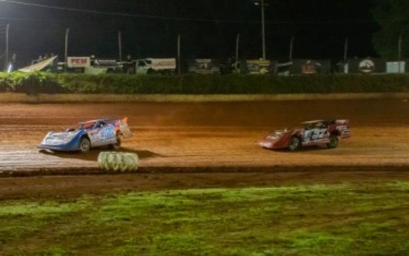 Cooper Twiggs of Murphy (left, No. 100) and Spanky Barnett of Blue Ridge, Ga. (right, No. 27) take laps during the race at Tri-County Racetrack on June 6.