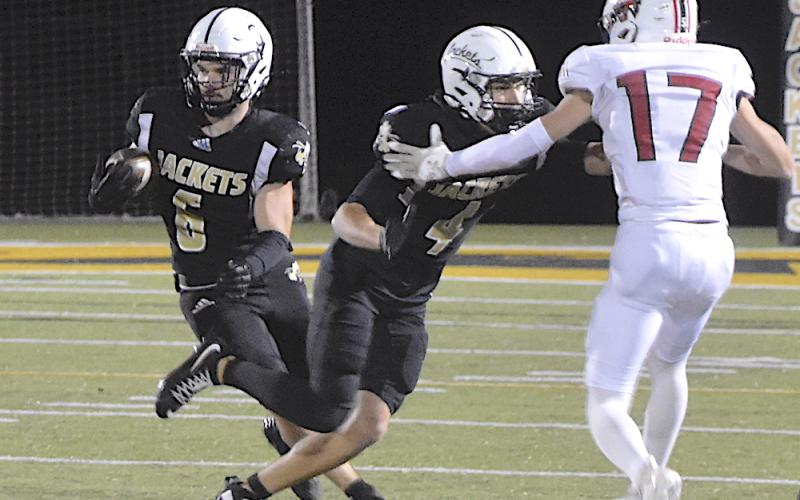 Gary Corsair • Clay County Progress Hayesville's Tre Graves, No. 6, takes advantage of a block by Ben Bethel, No. 4, as he breaks off a long-gainer.