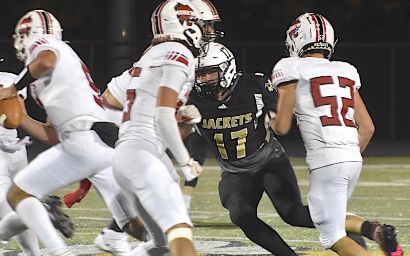 Gary Corsair • Clay County Progress Yellow Jackets defensive end Johan Webb, No, 17, powers his way between two Andrews blockers to break up a running play.