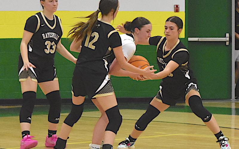 Gary Corsair • Clay County Progress Hayesville defenders Jasmine Brooks, No. 33, Olivia Free, No. 12, and Micalynn Moore, No. 10, make life difficult for a Bobcat.