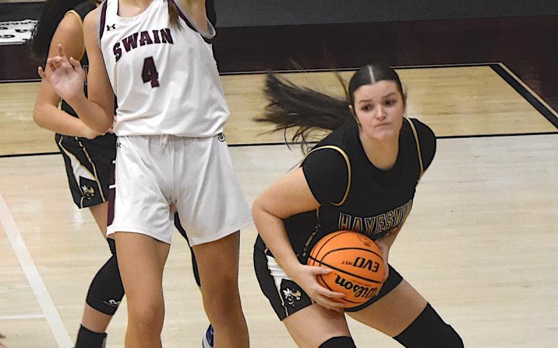 Gary Corsair • Clay County Progress Kayla Brown, No. 25, protects the rock after grabbing an offensive rebound at Swain County.