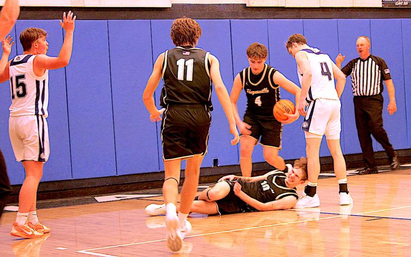 Neal Wachob • Clay County Progress Brady Reynolds, No. 11, and Daemien Soto, No. 4, come to the aid of their fallen teammate as Hayesville's Brendan Lynch, No. 10, grimaces in pain after being fouled.