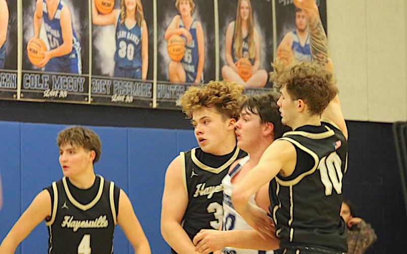 Neal Wachob • Clay County Progress Jackson Sellers, No. 33, and Brendan Lynch, No. 10, apply a Hayesville denial sandwich to Nantahala's center while Daemien Soto, No. 4, eyeballs the ball.