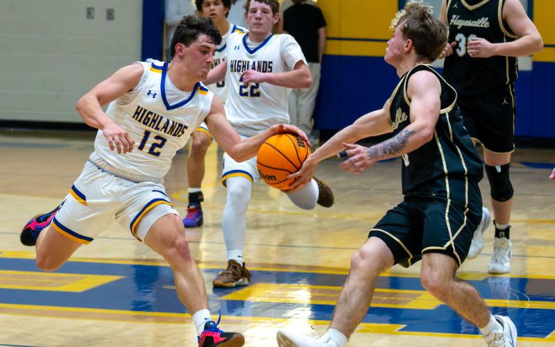 Todd Sumner • Photo Hayesville spark plug E.J. Abrams, No. 0, disrupts a Highlands fast break as teammate Jackson Sellers, No. 33, trails the play.