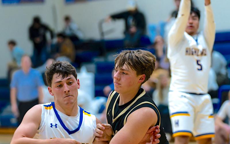Todd Sumner • Photo Landon Trout, No. 15, stakes his claim on a defensive rebound for Hayesville.