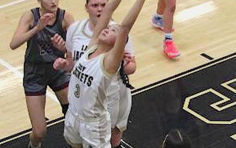 Neal Wachob • Clay County Progress Lucy Trout, No. 3, stretches for a rebound as the Hayesville trio of Trout, Ava Moore, No. 42, and Micalynn McClure, No. 10, attack the glass against Swain County.