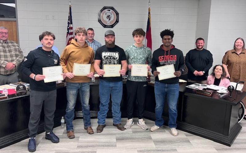 Angel Owens • Photo Hayesville athletes recognized at the Board of Education meeting were, from left, Tre Graves, Kaden Ledford, Brendon Collins, Ben Bethel and Will Brown. School board members are, from left, Danny Jones, Chairman Jason Shook, Josh Ashe, Kelly Crawford and Superintendent Melissa Godfrey.