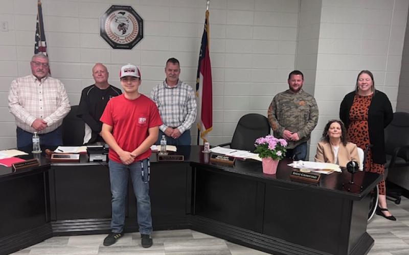 Angel Owens • Photo Hayesville High School senior, front, Adrian Fuentes shared his Career and Technology Education Internship with the Clay County Board of Education, from left, Danny Jones, Robert Caldwell, Chairman Jason Shook, Josh Ashe, Kelly Crawford and Superintendent Melissa Godfrey during the regular meeting. Ledford and Parker sponsored the internship.