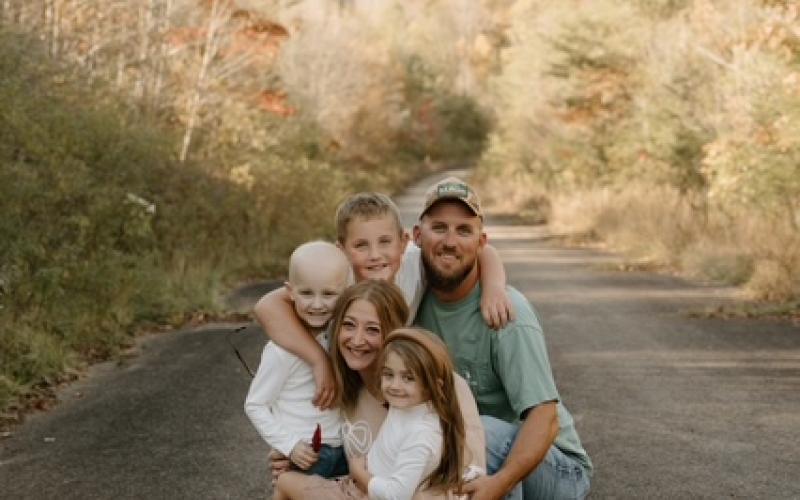 Katie Wood Photography The Lovingood Family, from front to back, Rowen, Caitlin, Rhet, Grady and Derrick on a country road in Hayesville in 2024, shortly after Rhet began treatment for leukemia.