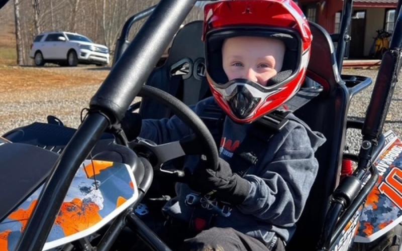Caitlin Lovingood • Photo Rhet Lovingood was suited up for a ride through the family's backyard in Hayesville on Sunday, March 22. Rhet's gas-powered go-cart is a part of his play routine when weather is permitting.