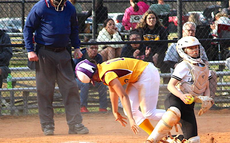 Neal Wachob • Clay County Progress Hayesville's catcher Caroline Wade looks for another Lady Brave to erase after tagging out a runner at home.