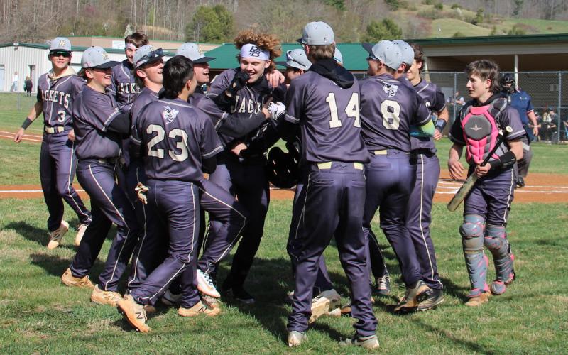 Neal Wachob • Clay County Progress Hayesville's Jackson Sellers is mobbed by teammates as he returns to the dugout after blasting a fence-clearing dinger at Robbinsville on Friday.