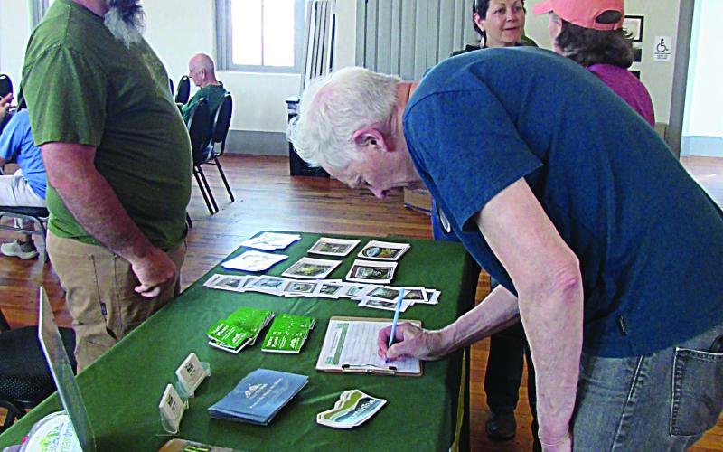 Rob Tiger signs in for Thursday evening's town hall on the Roadless Rule. The meeting was held at the Historic Courthouse Beal Center.