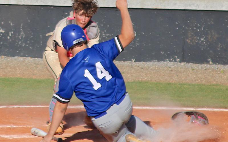 Hayesville catch Jaxson Caruso applies the tag as Hiawassee Dam's Wyatt Davenport tries to score.