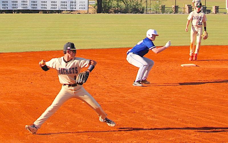 A Hiawassee Dam base runner is caught in limbo after Hayesville third baseman Brady Gerdes gloves a hot shot and prepares to throw to first.