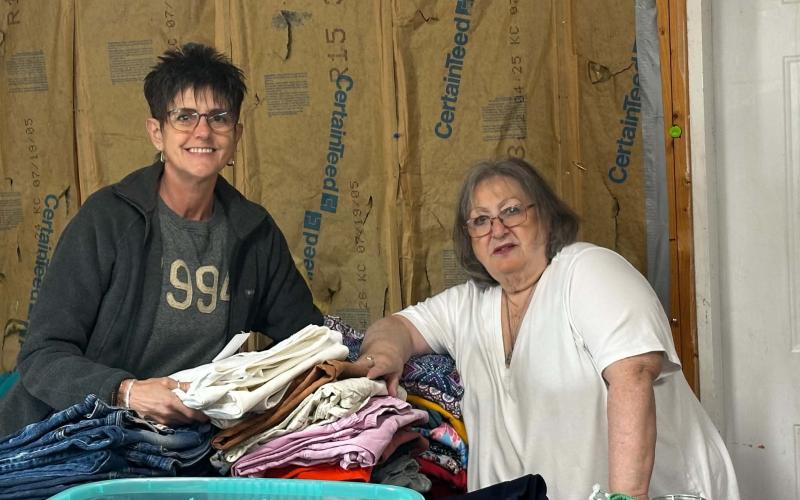 Lorrie Ross • Clay County Progress Volunteer Kim Odom, on left, enjoys sorting childrens' clothes with Pam Storring, another volunteer. The Allens welcome anyone who wants to volunteer. Odom said they are such great people to volunteer with, she drives from south of Blairsville to help.