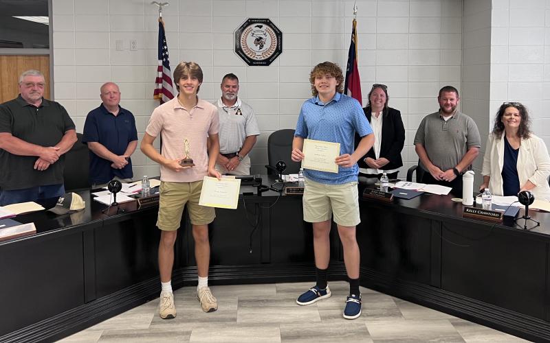 Jackets Varsity Basketball athletes Brady Reynolds, All Conference, and Jackson Sellers, Honorable Mention, received Winter Sport Recognition certificates during the Clay County School Board of Education meeting on Monday, May 18. Back from left, board members Danny Jones, Robert Caldwell, Chairman Jason Shook, Superintendent Melissa Godfrey, board members Josh Ashe and Kelly Crawford.