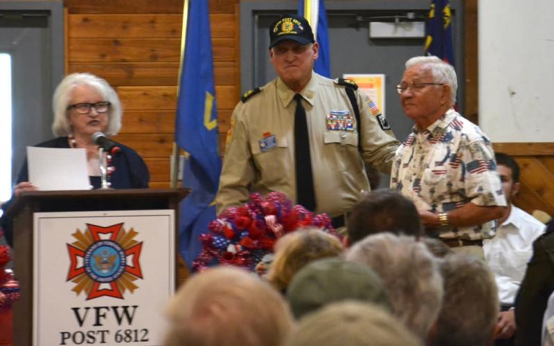 Betty Bradley and Post Commander John Clodfelter presents an award to veteran Jim Ledford who spent 30 years in the military.