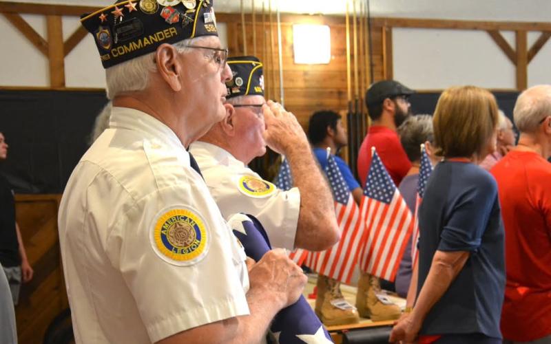 Phil Cantley and Rondal Brown begin the flag folding ceremony at the Memorial Day Service.