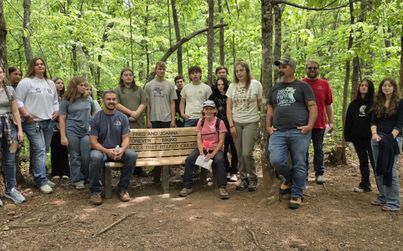 From left, Sophie Sommer, Hannah Bradshaw, Amelia Manning, Madalynn Nemkovich, Karla Slade, Bailey Reeves, Hailey Mulkey, Teacher Silas Brown, Eli White, Layne Ledford, Axel Alburto, Kaden Ledford, Joanna Atkisson, Jacob Lee, Ephraim Jones, Maggie McClure, Tony Ward, Tyler Osborn, Alexis Spain and Erica Dockery spent the day learning about the history of the trail system and plants growing there.