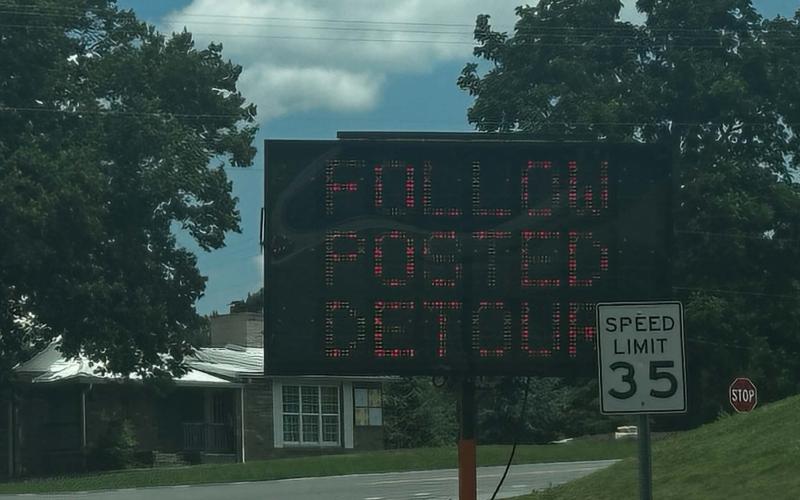 Digital message signs warn of a detour ahead. This one is on School Drive near Yellow Jacket Drive.