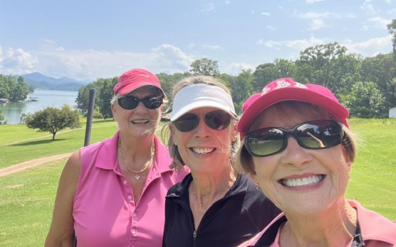 From left, golfers Linda Miles, Judy Aube and Linda Robinson take a break from the heat.