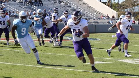 (Submitted • Catamount Sports) Tyrie Adams runs away from defenders. Adams accounted for nearly 300 yards of offense and two touchdowns.