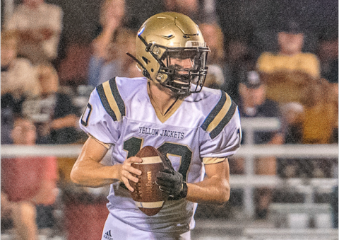 (Photo by Kevin Hensley) Quarter back Hayden McClure scrambles as he looks for an open receiver.