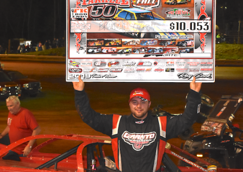(Travis Dockery • Clay County Progress) “Big Sexy” Brandon Overton proudly shows of his reward for winning the 16th Tarheel 50 at Tri County Racetrack.