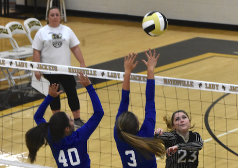 (Travis Dockery • Clay County Progress)  Jena Baldwin pushes the ball just over the finger tips of Hiwassee Dam’s net defender.
