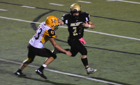 (Progress photo by Travis Dockery) Junior running back Blake McClure throws a stiff arm in the first steps of an 80-yard run.