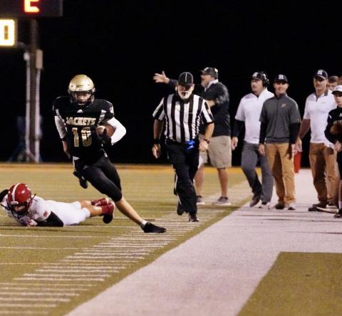 (Kelli Graves • Clay County Progress) Quarterback Hayden McClure is careful to stay inbounds during a run.