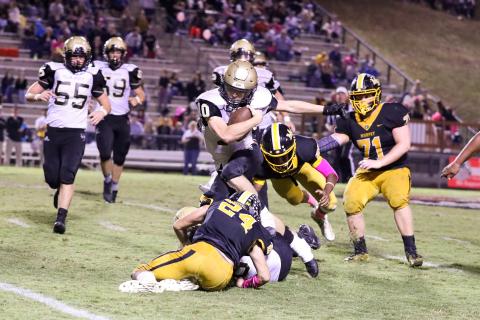 (Kelli Graves • Clay County Progress) Quarterback Hayden McClure ping-pongs off of several defenders in search of points.