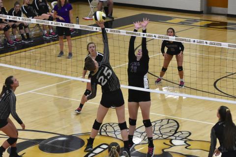 Senior Kat Davis wins the battle at the net as she sends the ball towards an open gap on the floor.  Travis Dockery • Clay County Progress