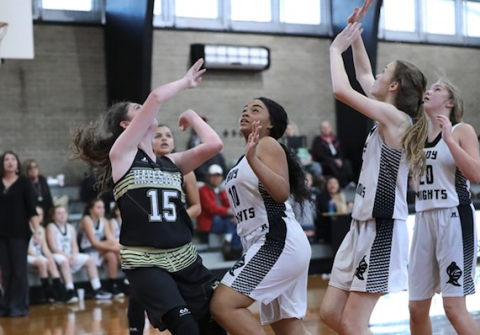 (Kelli Graves  • Clay County Progress) Madison Martin battles a trio of Lady Knights underneath the basket Monday.