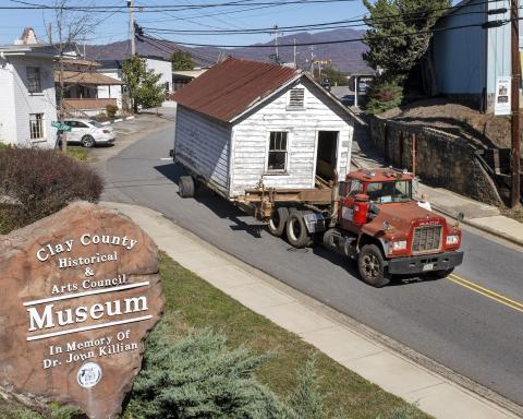 The old Hayesville Town Hall came slowly down Main Street on equipment provided by Smith House Movers.