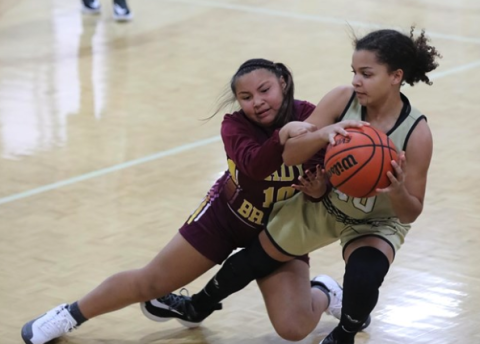 (Kelli Graves * Clay County Progress) Jayden Moore plays tug of war with a Lady Brave to try to keep possesion and stay in bounds.