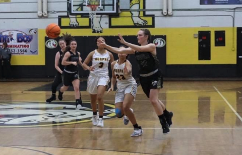 (Kelli Graves * Clay County Progress) Kynnly McClure shoots a pass across the court as Lady Bulldogs give chase.