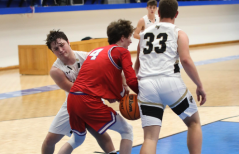 (Photo by Kelli Graves / Clay County Progress) Junior Blake McClure fights for the ball in the first round of the Battle of the States tournament. 