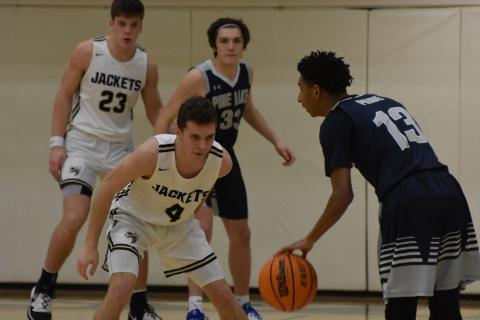 (Travis Dockery - Clay County Progress) Junior Hayden McClure has his eyes locked onto the ball just before making the steal against Pine Lake. 
