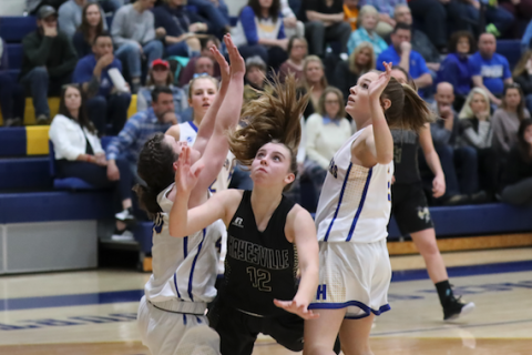 (Kelli Graves • Clay County Progress) Sophomore Lila Payne works between a pair of defenders and puts up a shot.