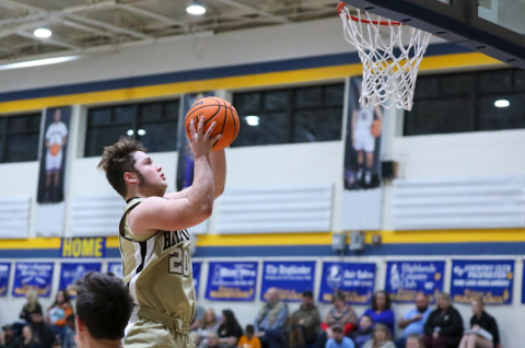 (Kelli Graves • Clay County Progress) Junior Blake McClure soars to the basket for 2 of his 8 points Monday.