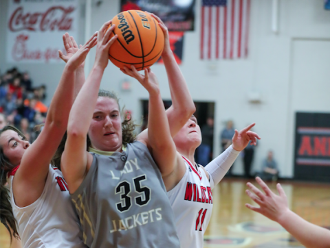 (Kelli Graves • Clay County Progress) Breanna Foster finds herself in a battle for the ball under- neath the basket.