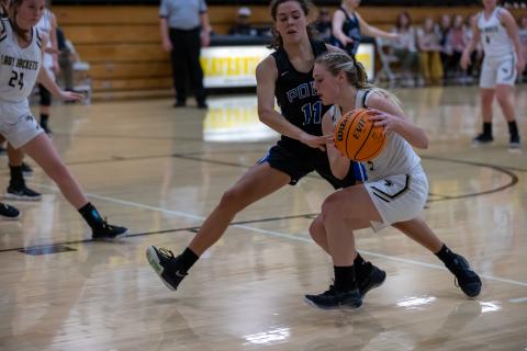 (Kelli Graves • Clay County Progress) Lizzy Brusini protects the ball as she drives the base line for 2 of her team-high 17 points to open the playoffs. 