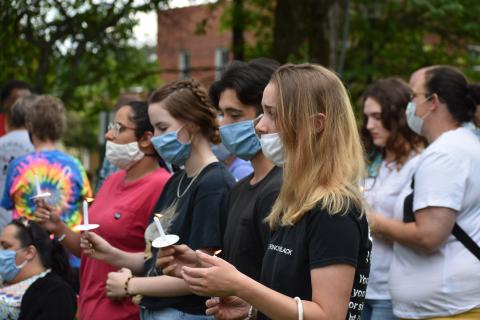 Photo by Becky Long/Clay County Progress: Those attending Tuesday night's vigil carry candles as a symbol of mourning for those who died unjustly and as an encouragement for peace among all citizens. More than 100 people attended the event.